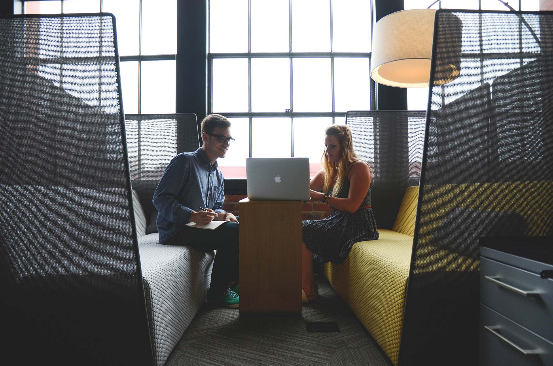 Man and woman collaborating on laptop.