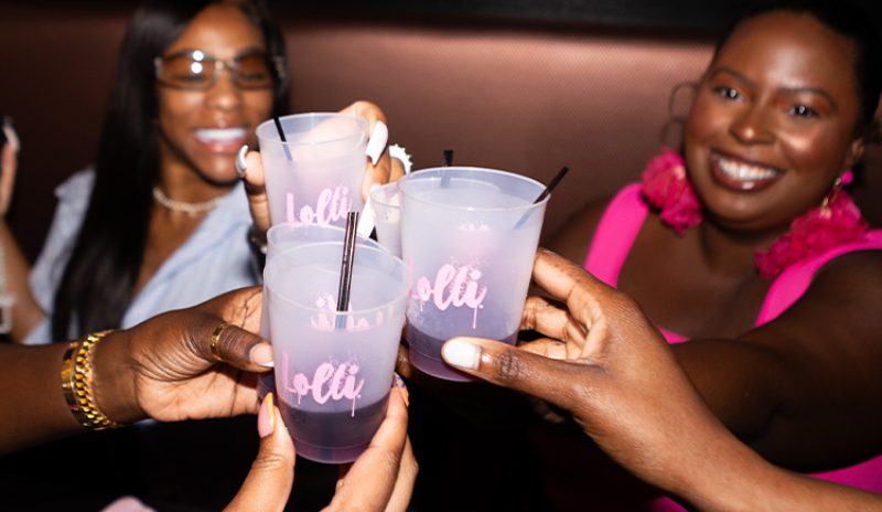 Friends toasting with Lolli drinks.